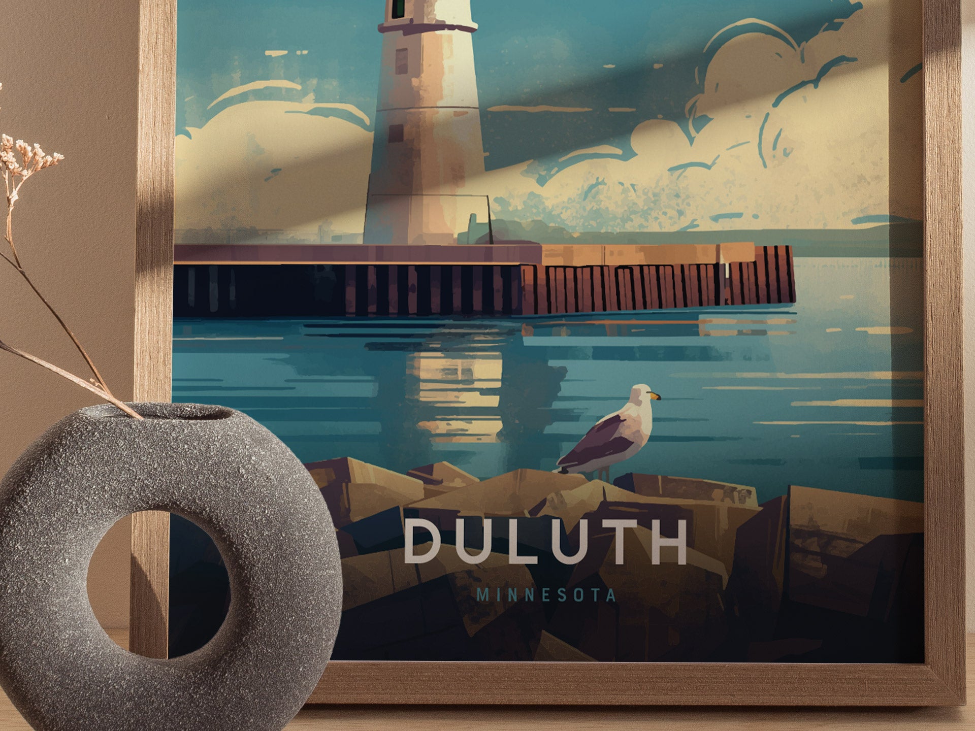 Illustrated poster of Duluth Harbor North Pier Lighthouse with blue sky and clouds, featuring a seagull on rocks. Modern round vase in the foreground adds decor contrast.