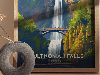 A framed poster of Multnomah Falls, showcasing a waterfall cascading behind a bridge, surrounded by lush greenery. A textured circular vase with dried flowers is positioned nearby.