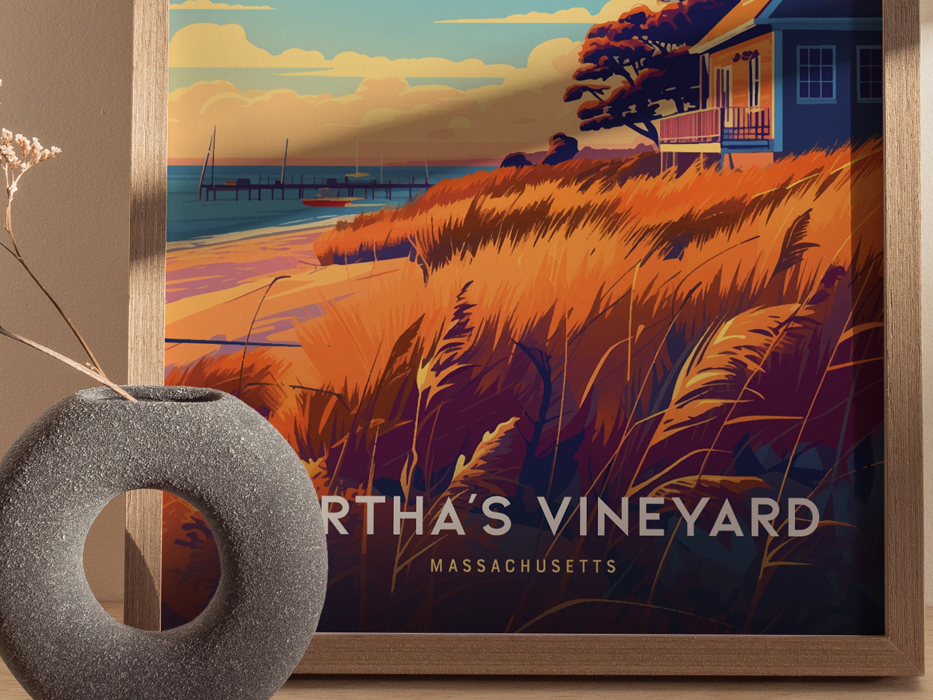A framed poster of Martha’s Vineyard features vibrant orange and blue coastal scenery with a house, pier, and beach grasses.
