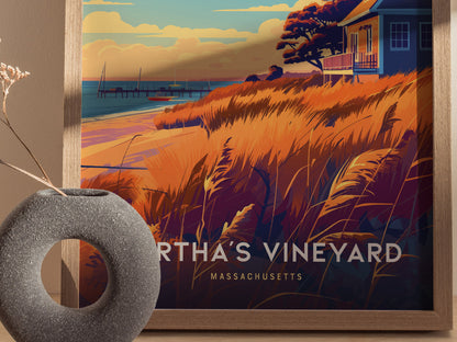 A framed poster of Martha’s Vineyard features vibrant orange and blue coastal scenery with a house, pier, and beach grasses.