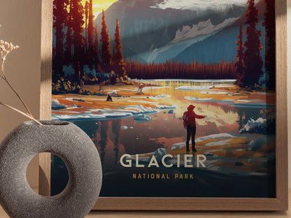 A framed poster depicting a scenic view of Glacier National Park with a person standing by a reflective lake surrounded by trees and mountains. A decorative vase sits nearby.