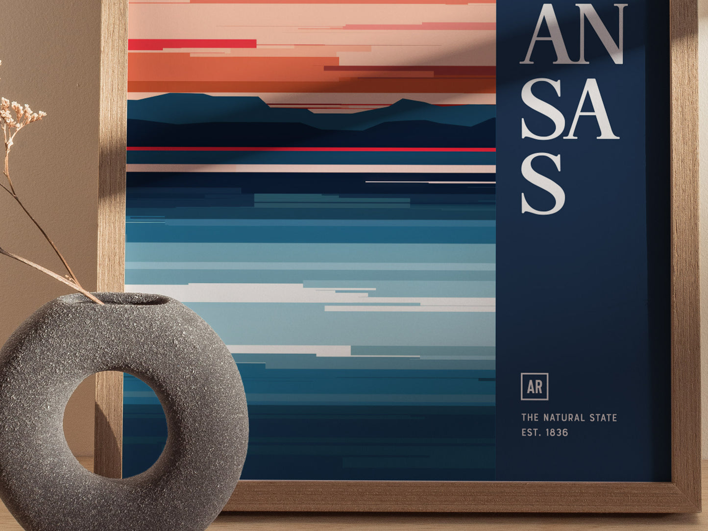 A minimalist poster with abstract horizontal stripes in warm and cool tones, partially obscured text reading ANSAS, and a decorative stone vase on the side.