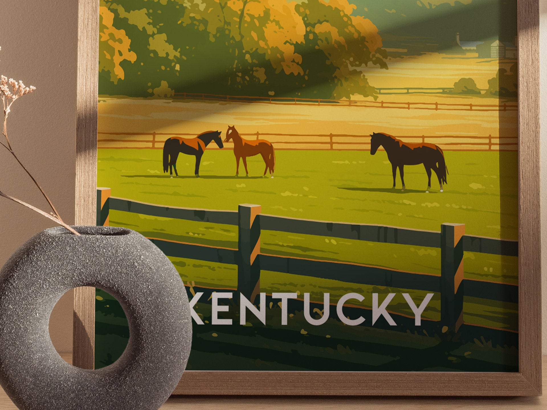 A framed poster depicts a scenic Kentucky landscape with horses grazing in green pastures, surrounded by black fences. The word Kentucky is visible at the bottom.