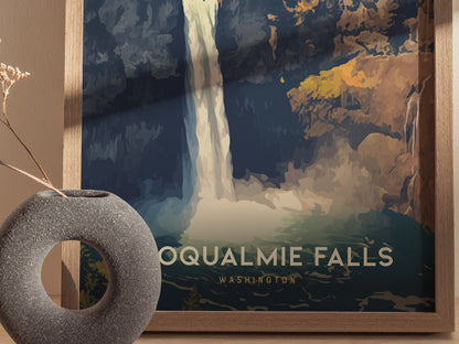A framed poster of Snoqualmie Falls in Washington, featuring a stylized waterfall with bold colors. In the foreground, a textured circular vase holds a dried plant.