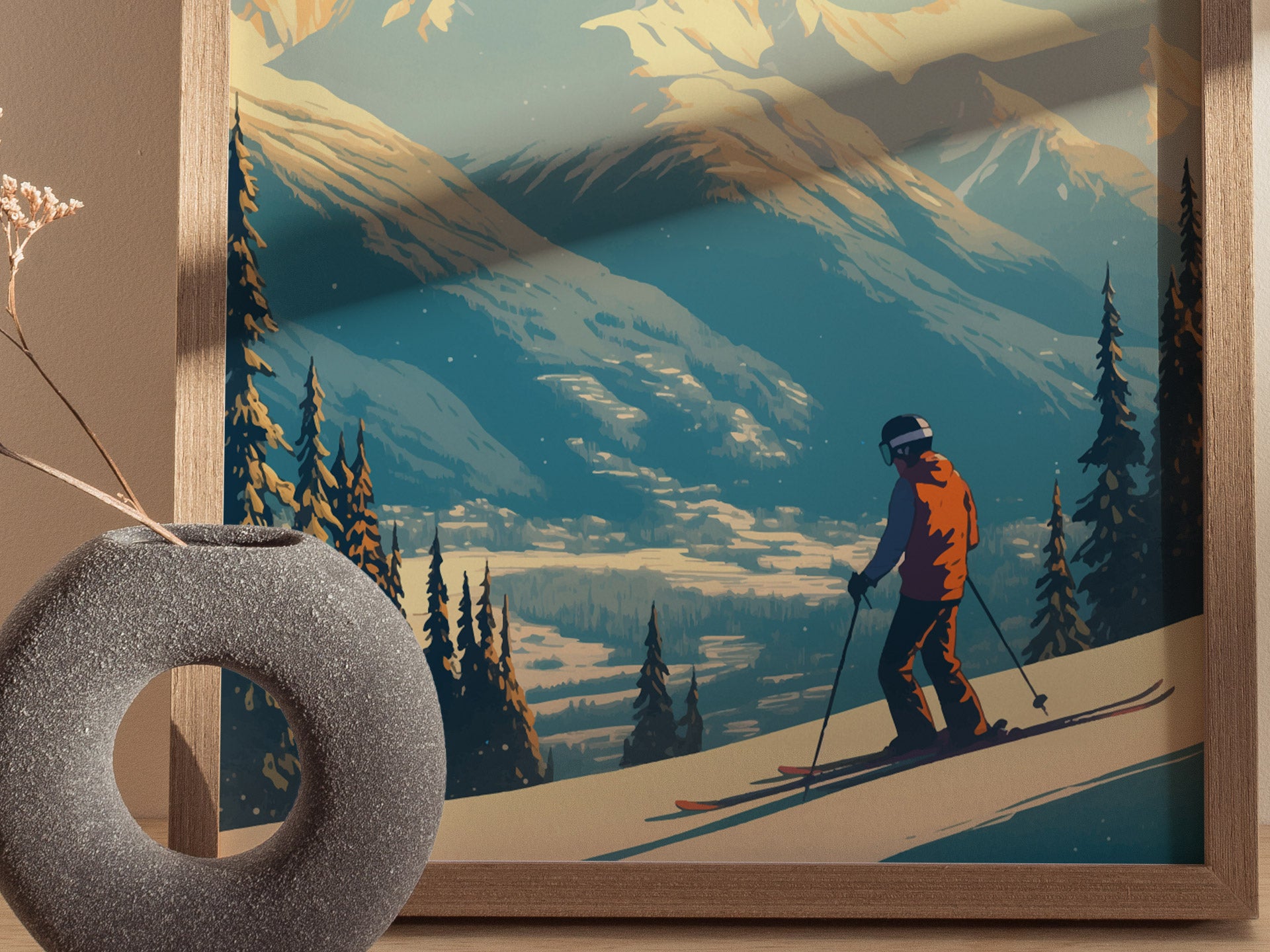 A framed illustration shows a skier in an orange jacket navigating a snowy slope against a backdrop of majestic mountains and evergreen trees, with a decorative vase in the foreground.