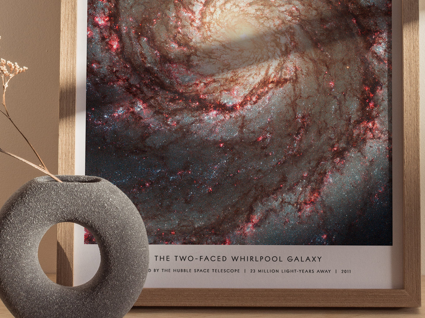 Close up of Whirlpool Galaxy poster showing bright spiral arms, dust lanes, and pink star-forming regions