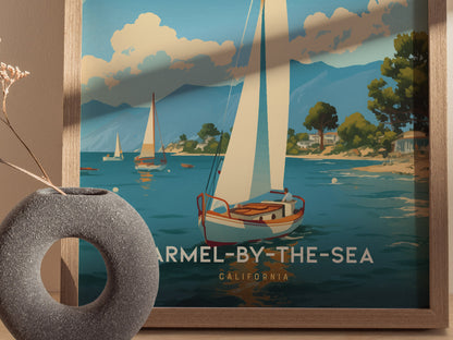 A framed poster depicts sailboats on a serene coastal scene in Carmel-by-the-Sea, California, with mountains and trees in the background. A decorative vase is placed nearby.