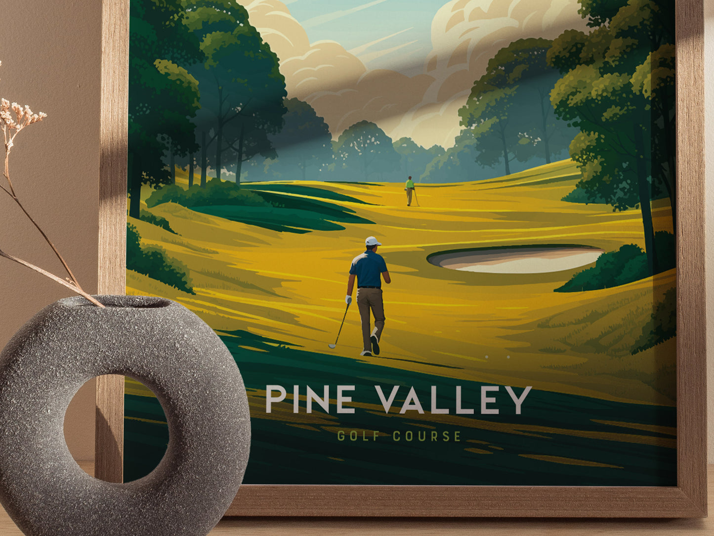 A framed poster of Pine Valley Golf Course shows two golfers on a vibrant, stylized fairway surrounded by lush trees, with a modern vase in the foreground.