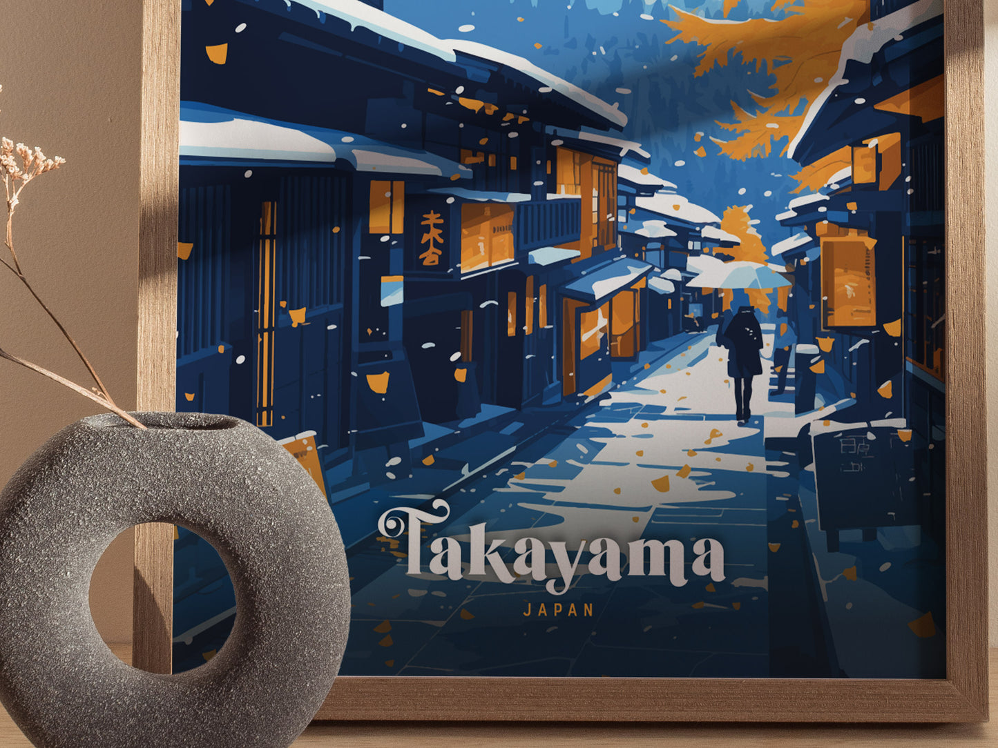 A framed poster depicts a snowy street in Takayama, Japan, with traditional wooden houses. A person walks with an umbrella, surrounded by falling leaves. A round vase is visible nearby.