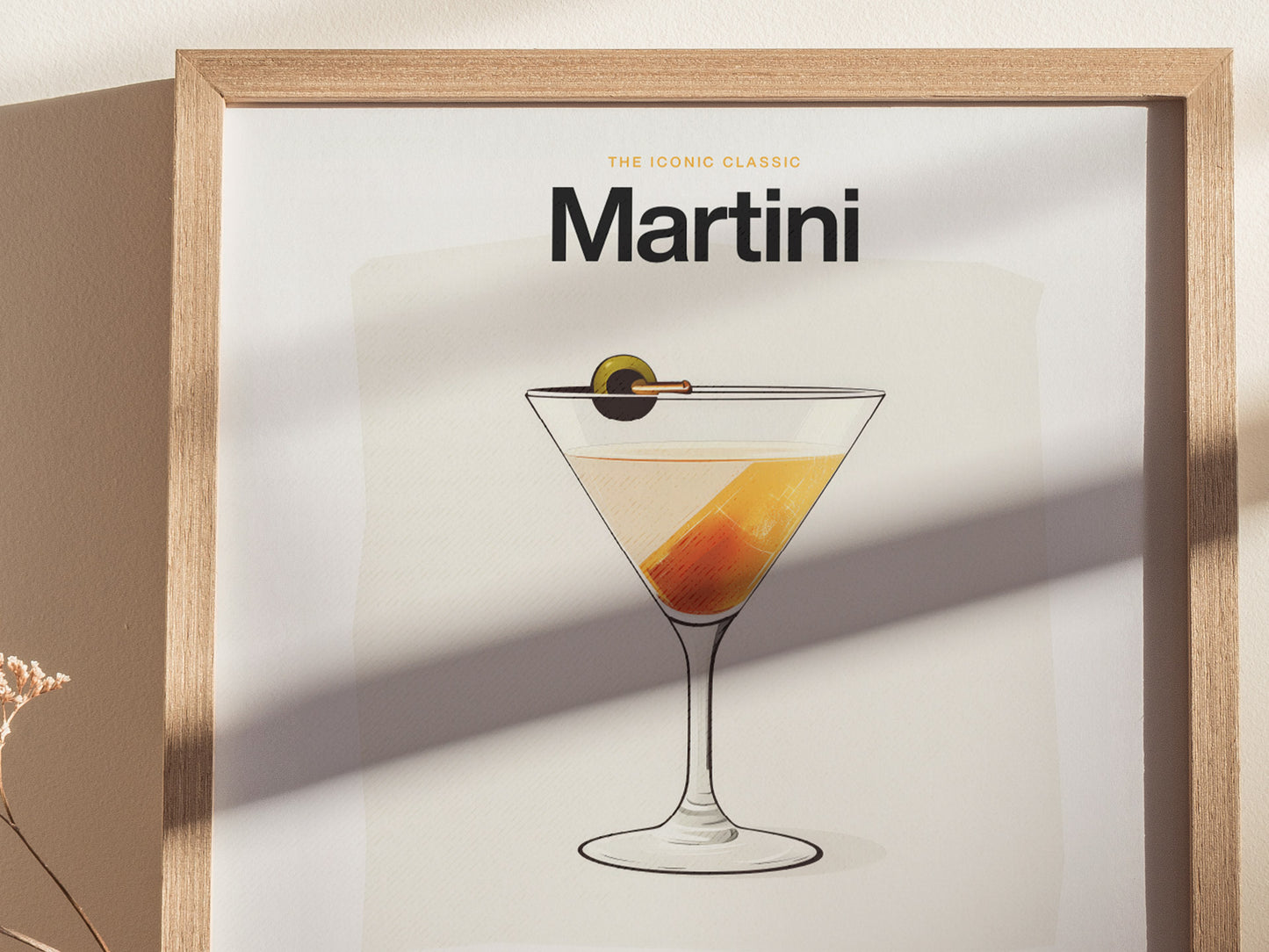 A framed poster features an illustration of a classic martini with an olive garnish. The words The Iconic Classic Martini are prominently displayed at the top.
