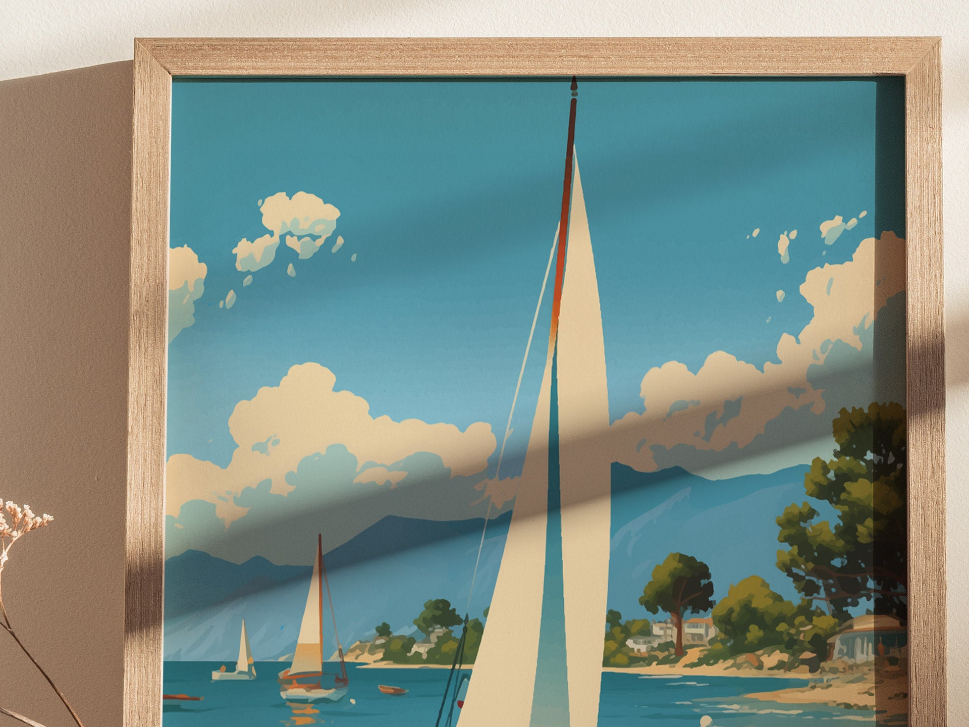 A framed poster depicts a serene coastal scene with sailboats on a tranquil sea, lush greenery, and fluffy clouds against a vibrant blue sky.