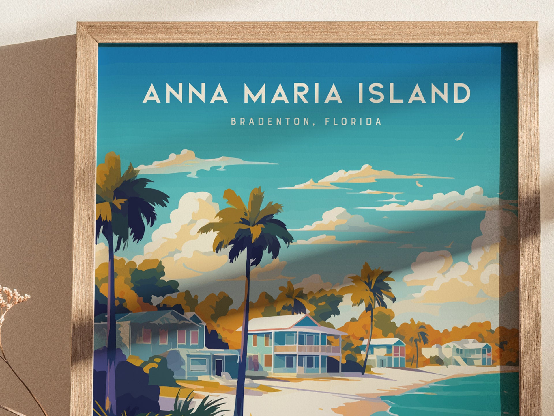 A framed poster of Anna Maria Island, Bradenton, Florida, featuring vibrant illustrations of palm trees and Key West-style beach cottages along a serene shoreline under a blue sky with clouds.