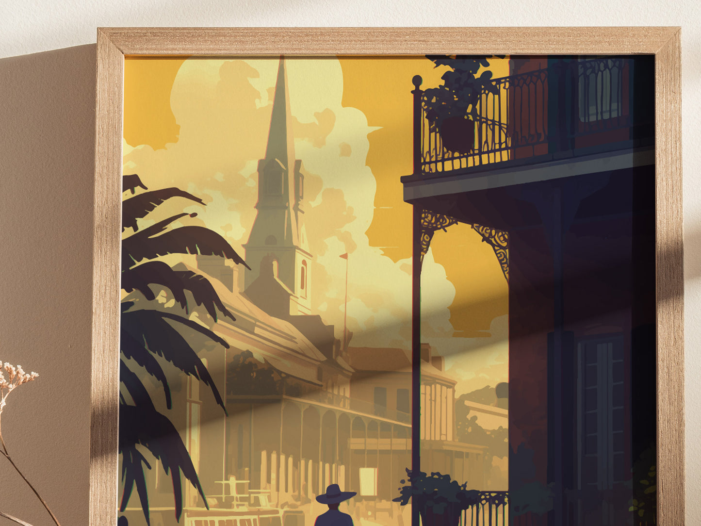 A framed poster depicts the French Quarter in New Orleans, featuring detailed illustrations of historic architecture, a church spire, and silhouetted palm trees against a warm, golden sky.
