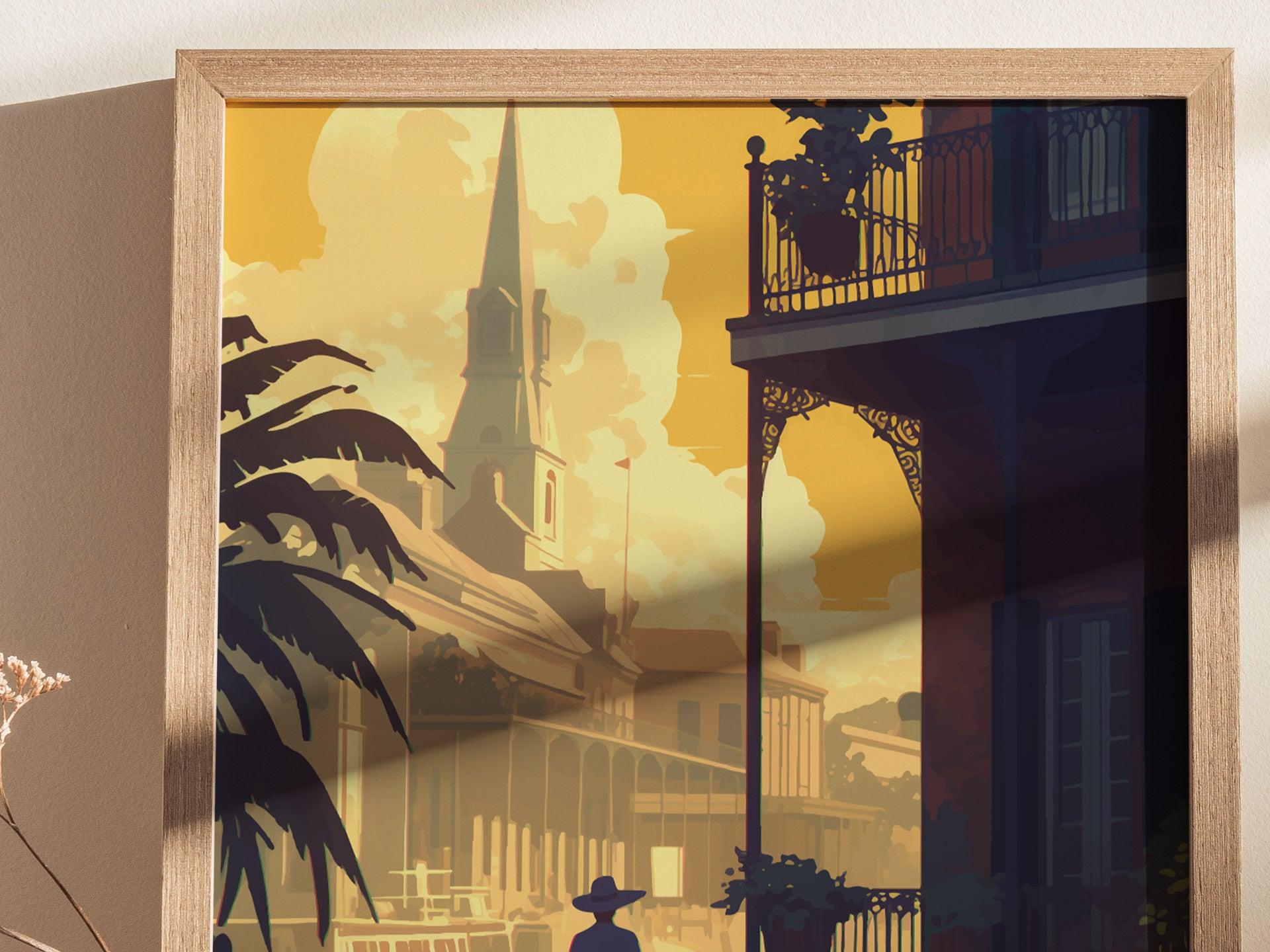 A framed poster depicts the French Quarter in New Orleans, featuring detailed illustrations of historic architecture, a church spire, and silhouetted palm trees against a warm, golden sky.
