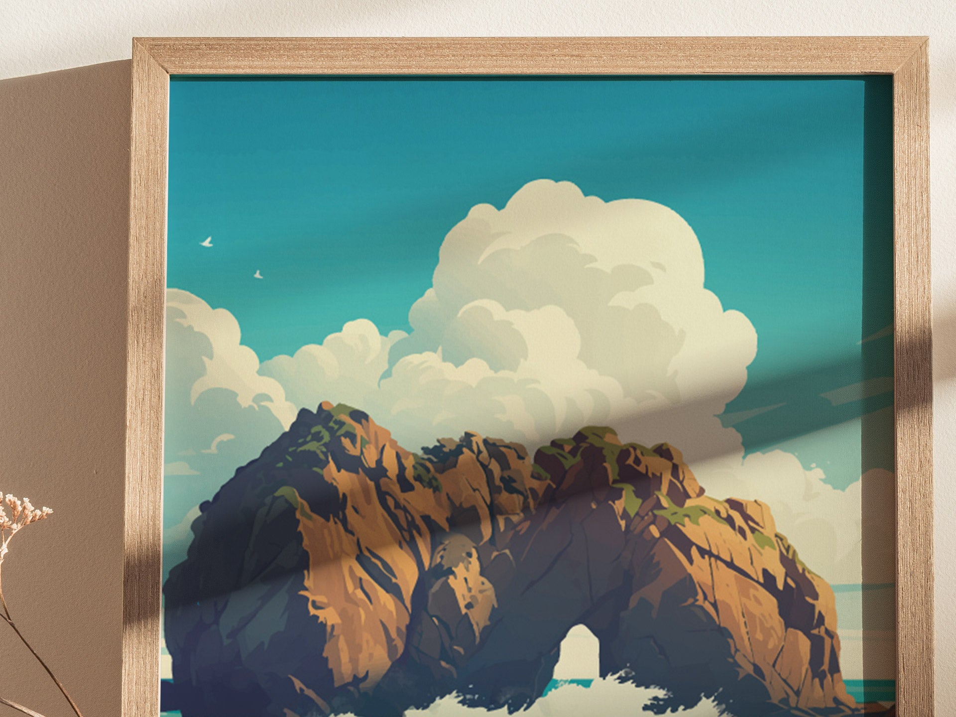 Framed artwork depicting Keyhole Rock at Big Sur, featuring a dramatic arch formation against a backdrop of vibrant blue sky and fluffy clouds. Two birds soar in the distance, enhancing the serene coastal scene.