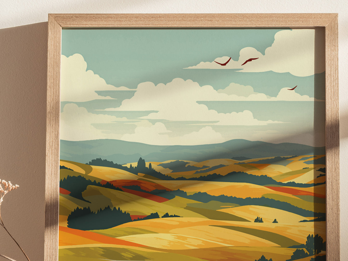 A framed poster depicting a scenic landscape with rolling golden hills, lush green fields, and a few birds flying under a partly cloudy sky. The style is artistic and serene.