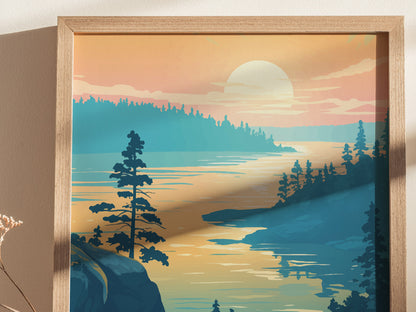 Framed artwork depicting a serene lake scene at sunset, with silhouetted trees and a glowing horizon. The colors are warm, creating a tranquil and picturesque landscape.