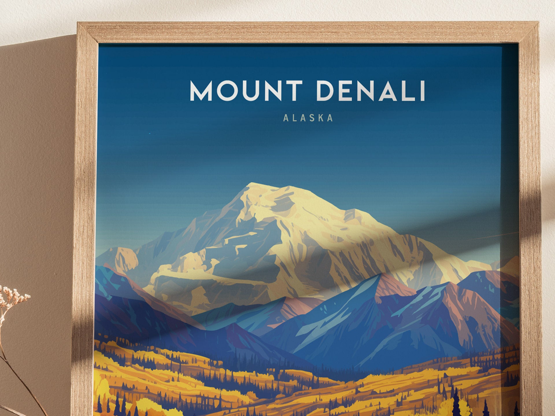 Framed artwork of Mount Denali with vibrant blue and yellow tones, showcasing the mountain and surrounding landscape under a clear sky. Ideal for home or office decor.