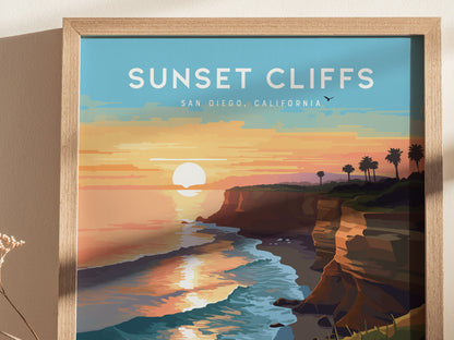 Framed artwork depicting a vibrant sunset over cliffs and ocean waves, with palm trees silhouetted against the colorful sky. Text reads Sunset Cliffs, San Diego, California.