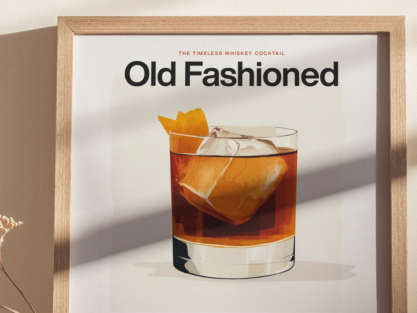 Framed poster featuring an illustration of an Old Fashioned cocktail with ice and an orange peel garnish, titled Old Fashioned in bold text. Soft shadows fall across the print.