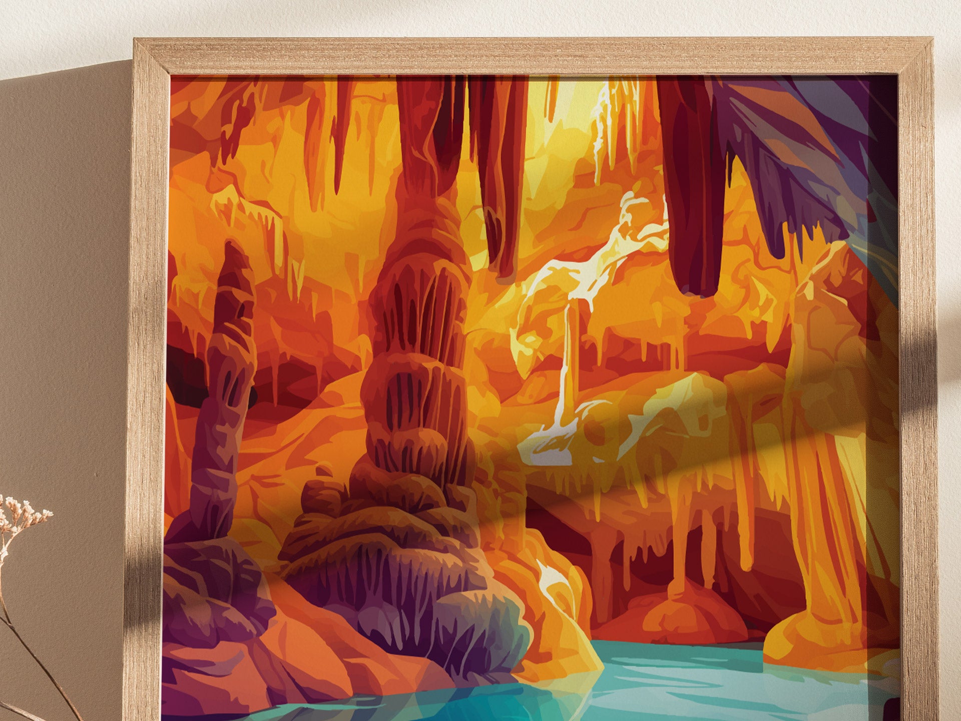 Brightly colored poster featuring stylized cave formations with vivid orange and purple hues, showcasing stalactites, stalagmites, and a serene turquoise pool, framed in light wood.