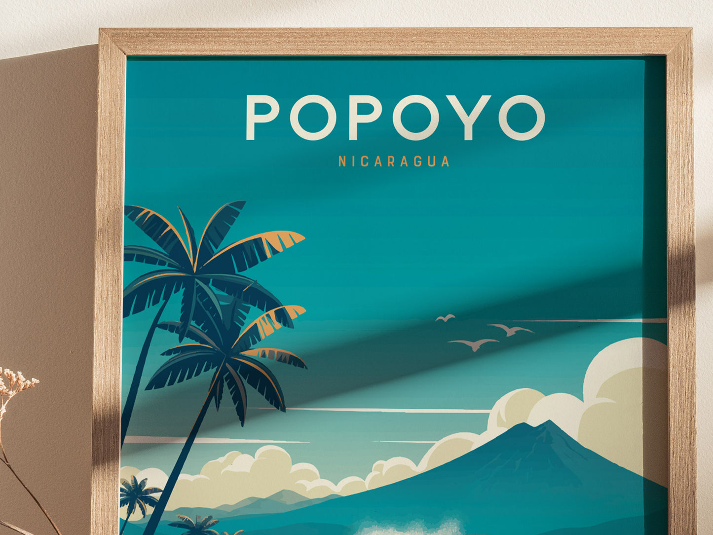 Framed poster with Popoyo Nicaragua text, featuring stylized palm trees, clouds, and birds against a turquoise sky. A volcanic mountain silhouette adds depth to the coastal scene.
