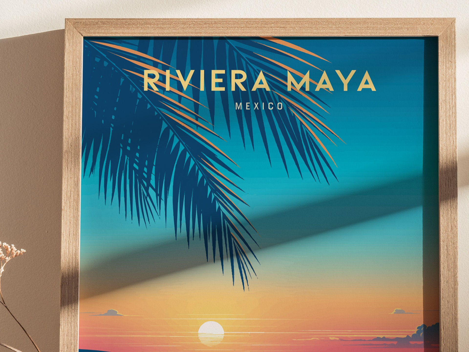A framed poster features a vibrant sunset over the ocean with palm leaves silhouetted against a gradient sky, titled Riviera Maya Mexico.