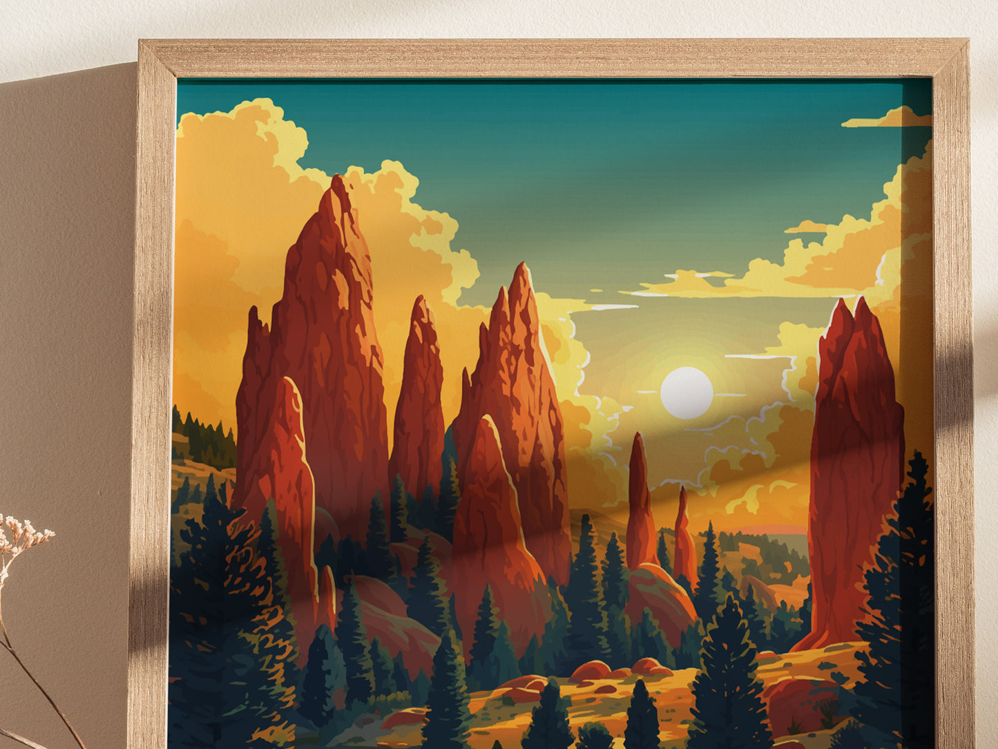 A framed poster depicts the dramatic red rock formations of Garden of the Gods under a vibrant sky with a setting sun, surrounded by silhouetted trees.