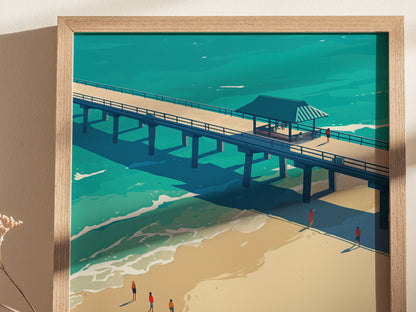 A framed poster depicts a stylized illustration of a pier extending over turquoise waters with small figures walking along the sandy beach, capturing a tropical coastal scene.