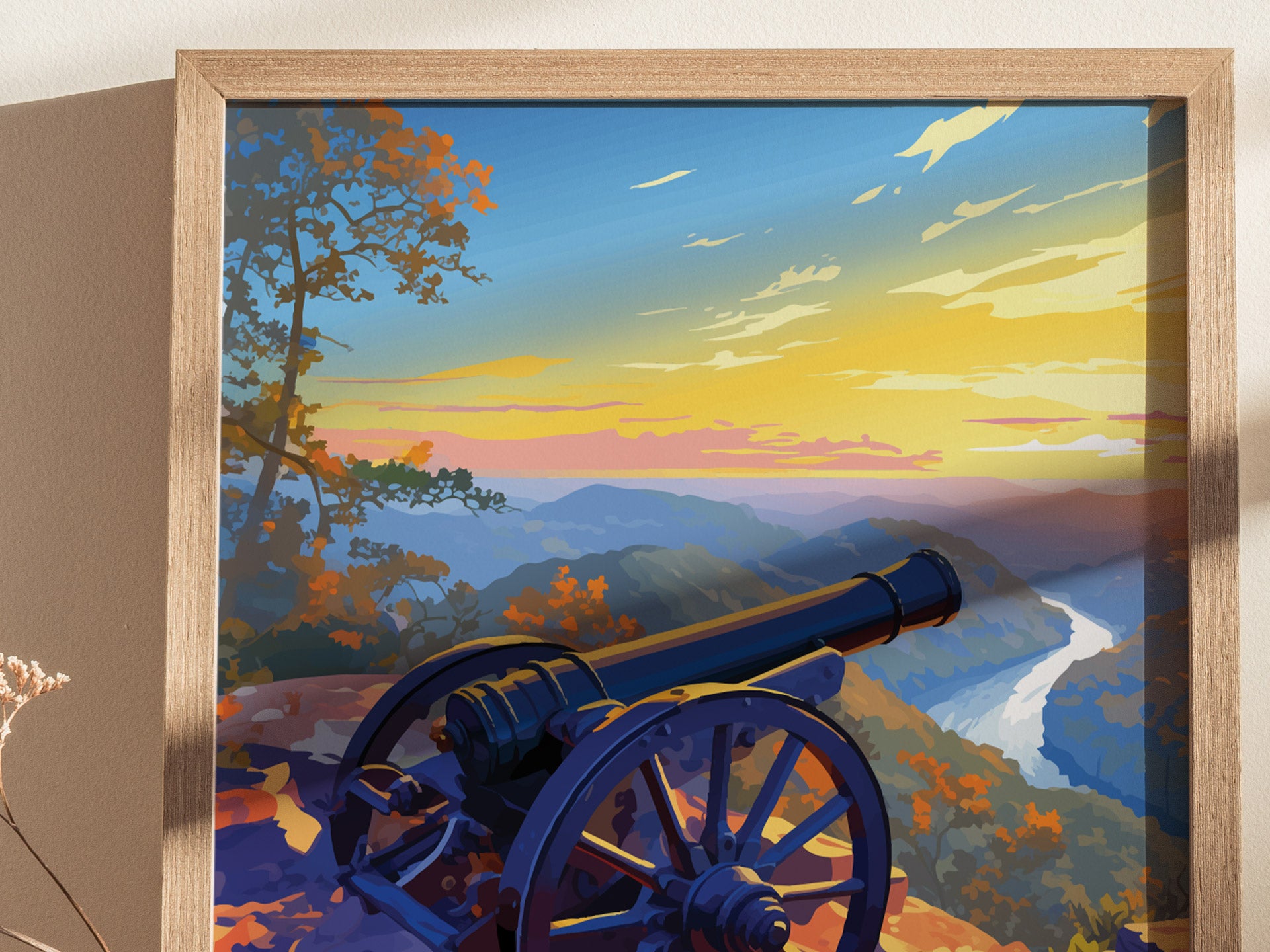 A framed illustration depicts a cannon overlooking a scenic sunset view of mountains and a winding river, with colorful foliage and a vibrant sky.