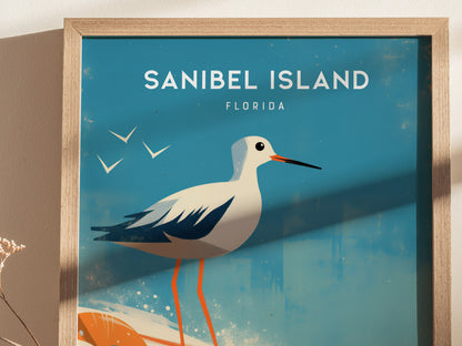A framed poster features a stylized sandpiper against a blue background with the text Sanibel Island, Florida and silhouettes of birds in flight.