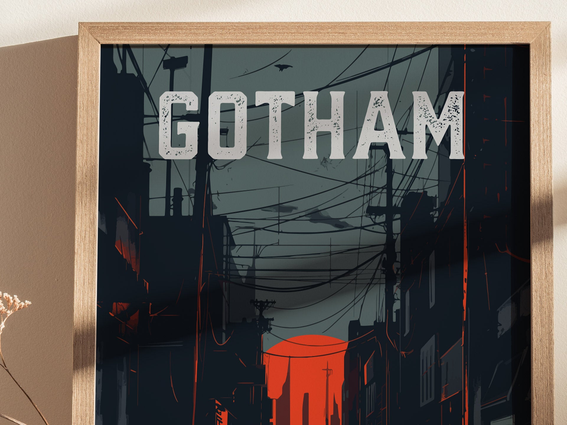 A framed poster of Gotham City features the word GOTHAM in bold letters against a dark, moody skyline. The scene includes silhouettes of buildings and power lines, with a striking red sun setting on the horizon.