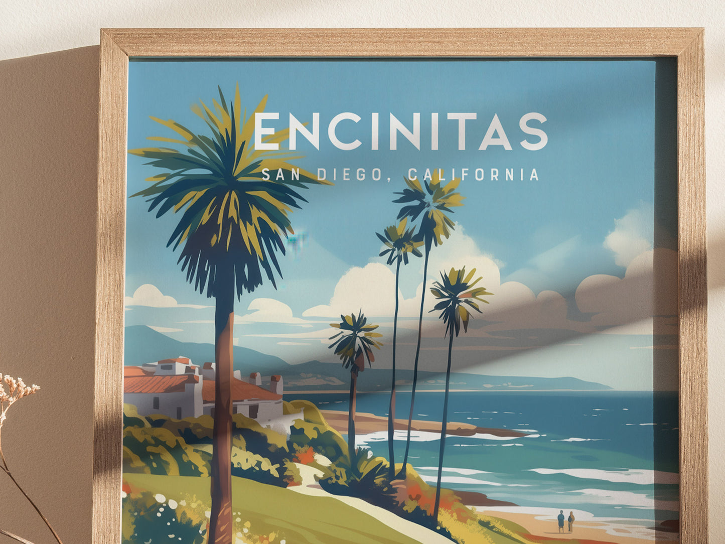 Framed artwork of Encinitas, California features a coastal scene with palm trees, ocean waves, and distant hills under a blue sky. The vibrant illustration captures a serene beach atmosphere.