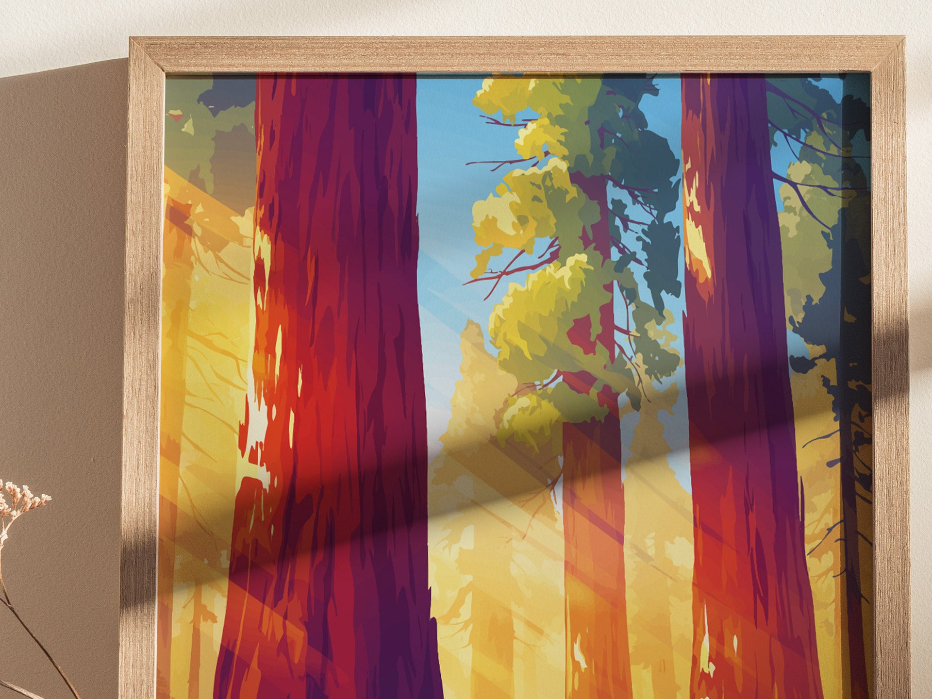 Illustration of towering sequoia trees with vibrant red trunks and green foliage, set against a bright blue sky. Framed art casting shadows on a neutral wall.
