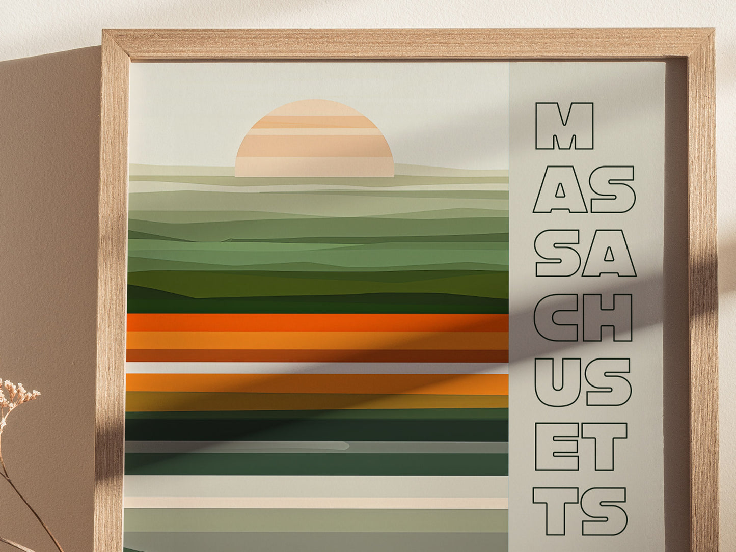 A framed poster with abstract green and orange horizontal stripes and a stylized sun, featuring the word MASSACHUSETTS vertically on the right side.