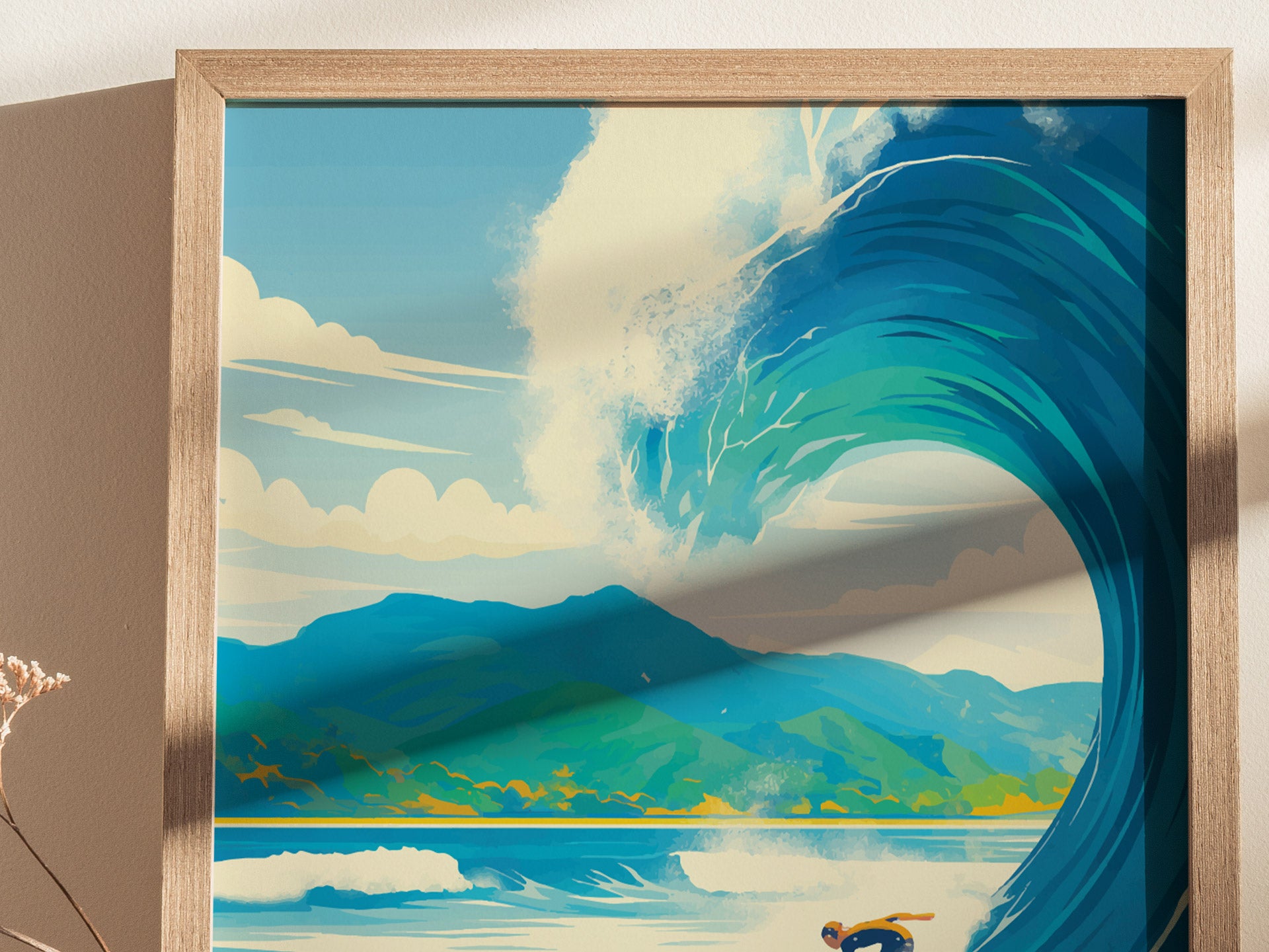 A framed poster depicts a vibrant ocean wave with a surfer below, set against a backdrop of lush green hills and a bright sky with fluffy clouds.