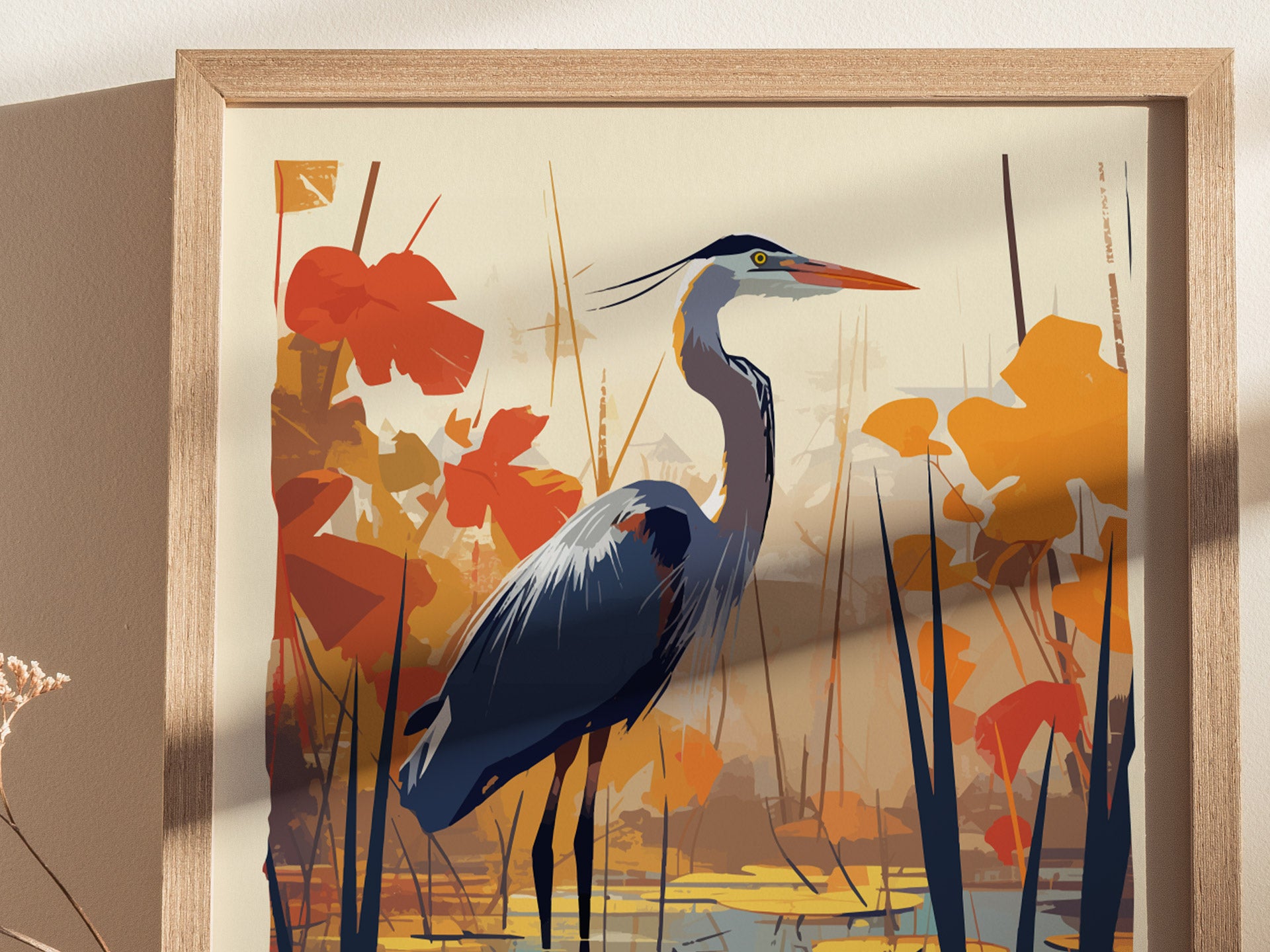 A framed poster features a stylized illustration of a great blue heron standing among orange and red foliage, with a serene water scene in the background.