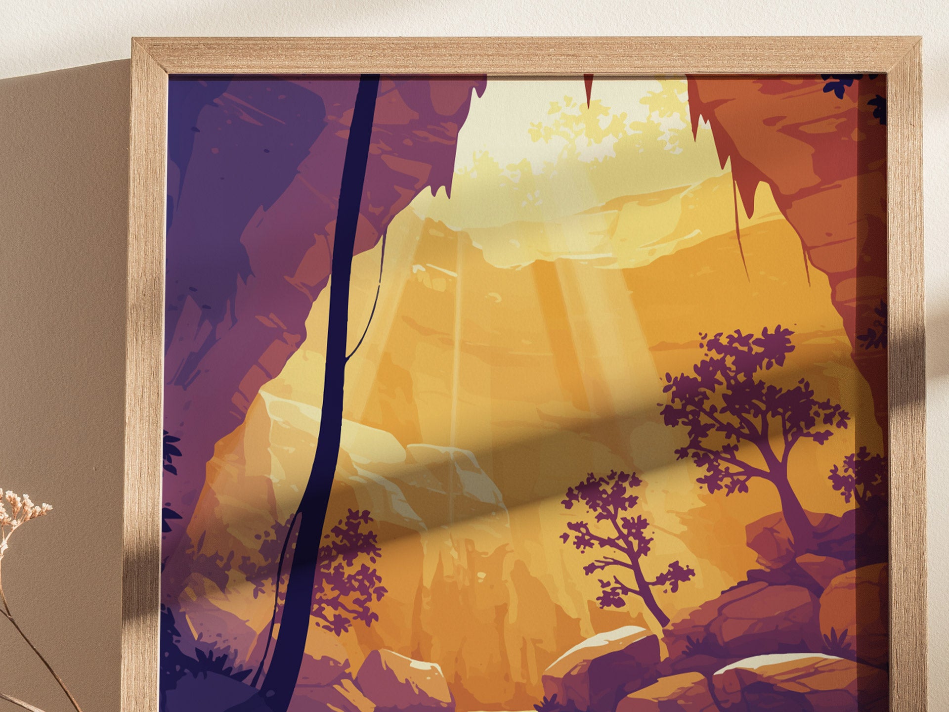 Illustrated poster depicting a cave scene with sunbeams streaming through an opening, illuminating rocky formations and silhouetted trees. Framed in light wood, it casts a warm, inviting ambiance.