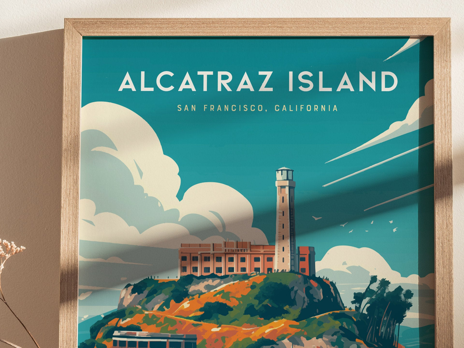 Framed poster of Alcatraz Island in San Francisco, featuring the iconic prison and lighthouse against a vibrant blue sky with stylized clouds. The artwork has a modern, colorful design.