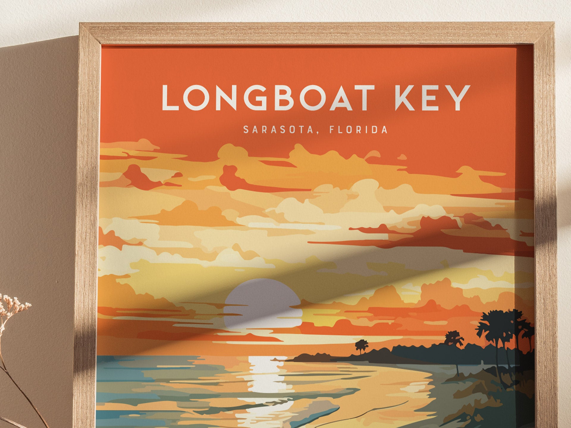 A framed poster featuring an artistic sunset over water with vibrant orange and yellow hues. Palm trees silhouette the horizon under a bold sky, with Longboat Key, Sarasota, Florida text at the top.
