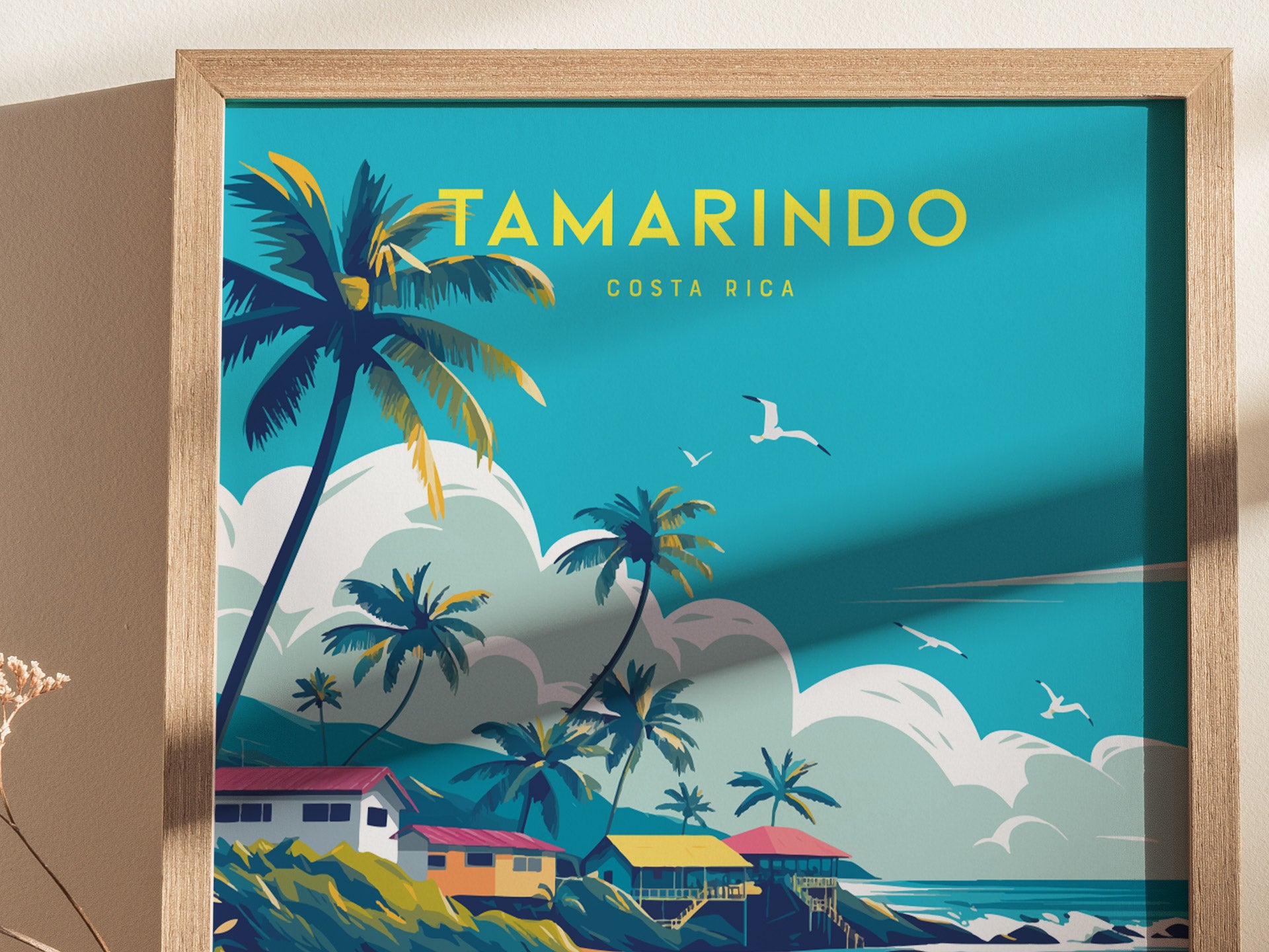 Colorful illustration of a coastal scene with palm trees, seagulls, and waves under a bright sky. The word Tamarindo is prominently displayed at the top of the poster.