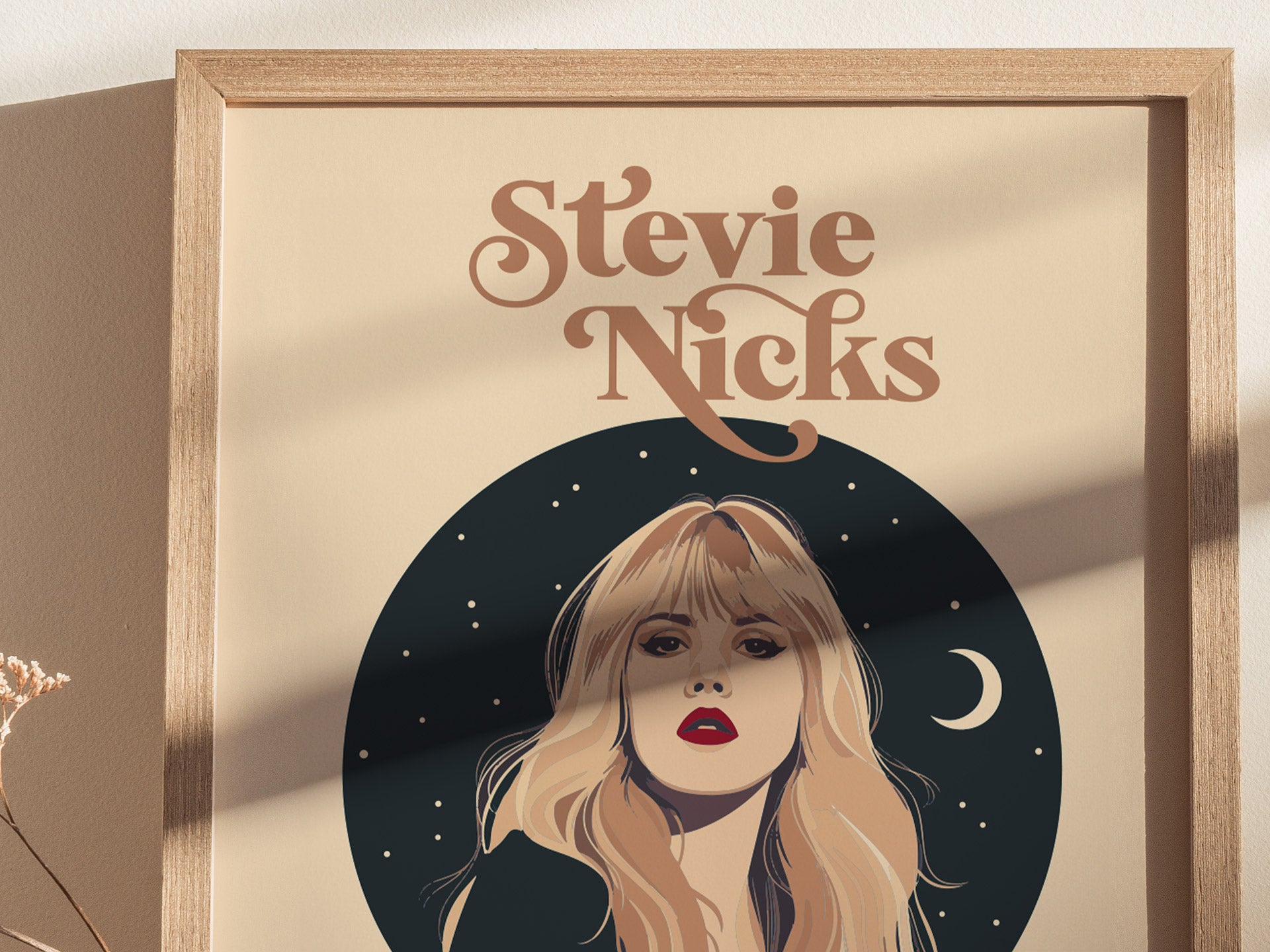 A framed poster features an illustrated portrait of a woman with long hair against a starry night sky and crescent moon, titled Stevie Nicks in stylized text.