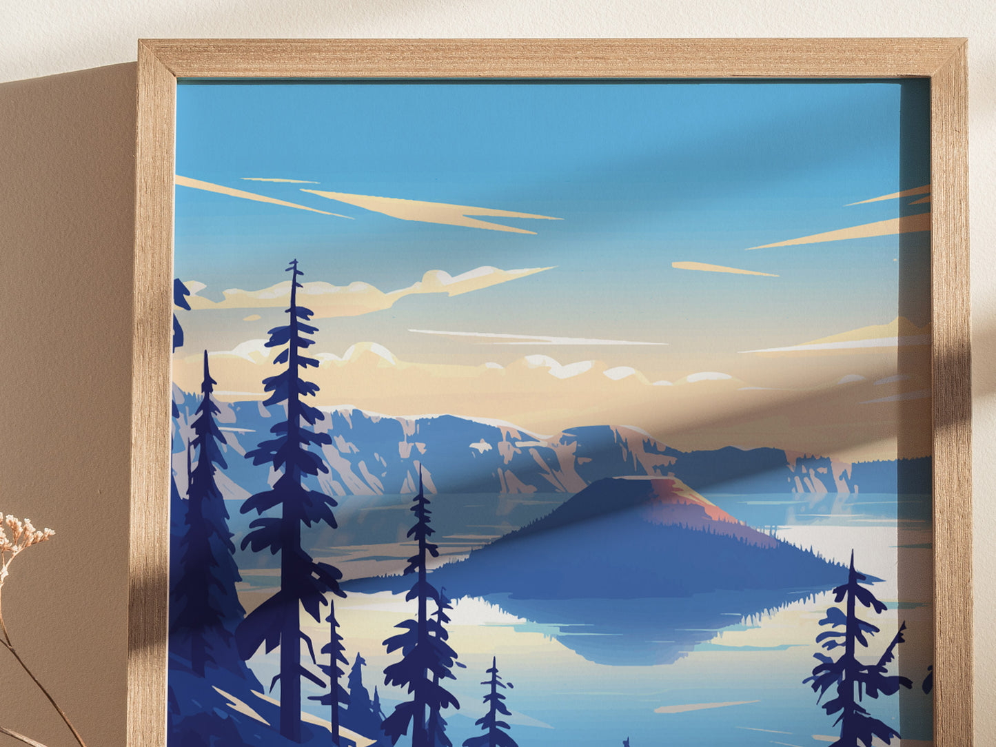 A framed poster depicts a stylized view of Crater Lake with vibrant blue waters, surrounding mountains, and tall pine trees under a clear sky.