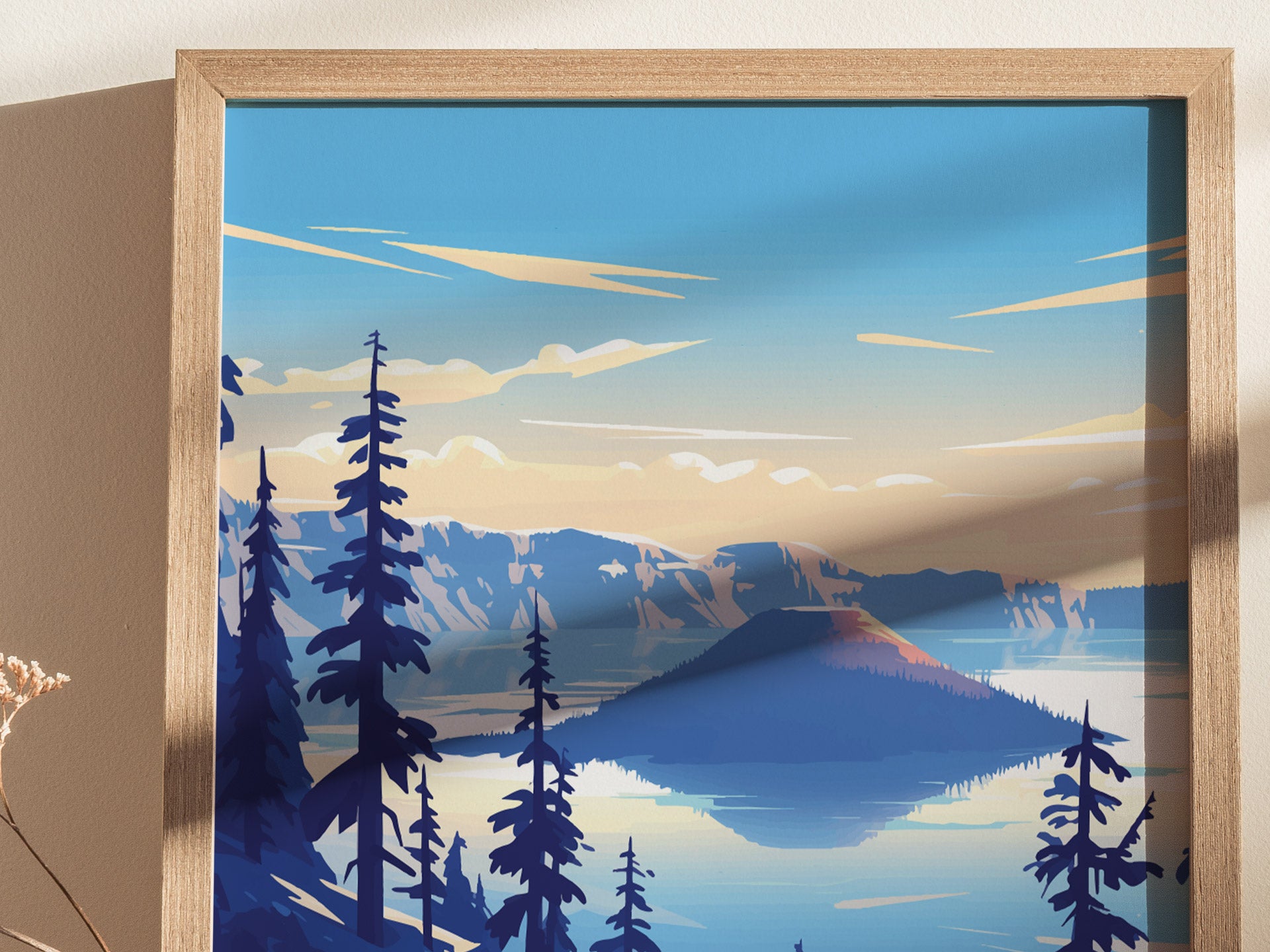 A framed poster depicts a stylized view of Crater Lake with vibrant blue waters, surrounding mountains, and tall pine trees under a clear sky.