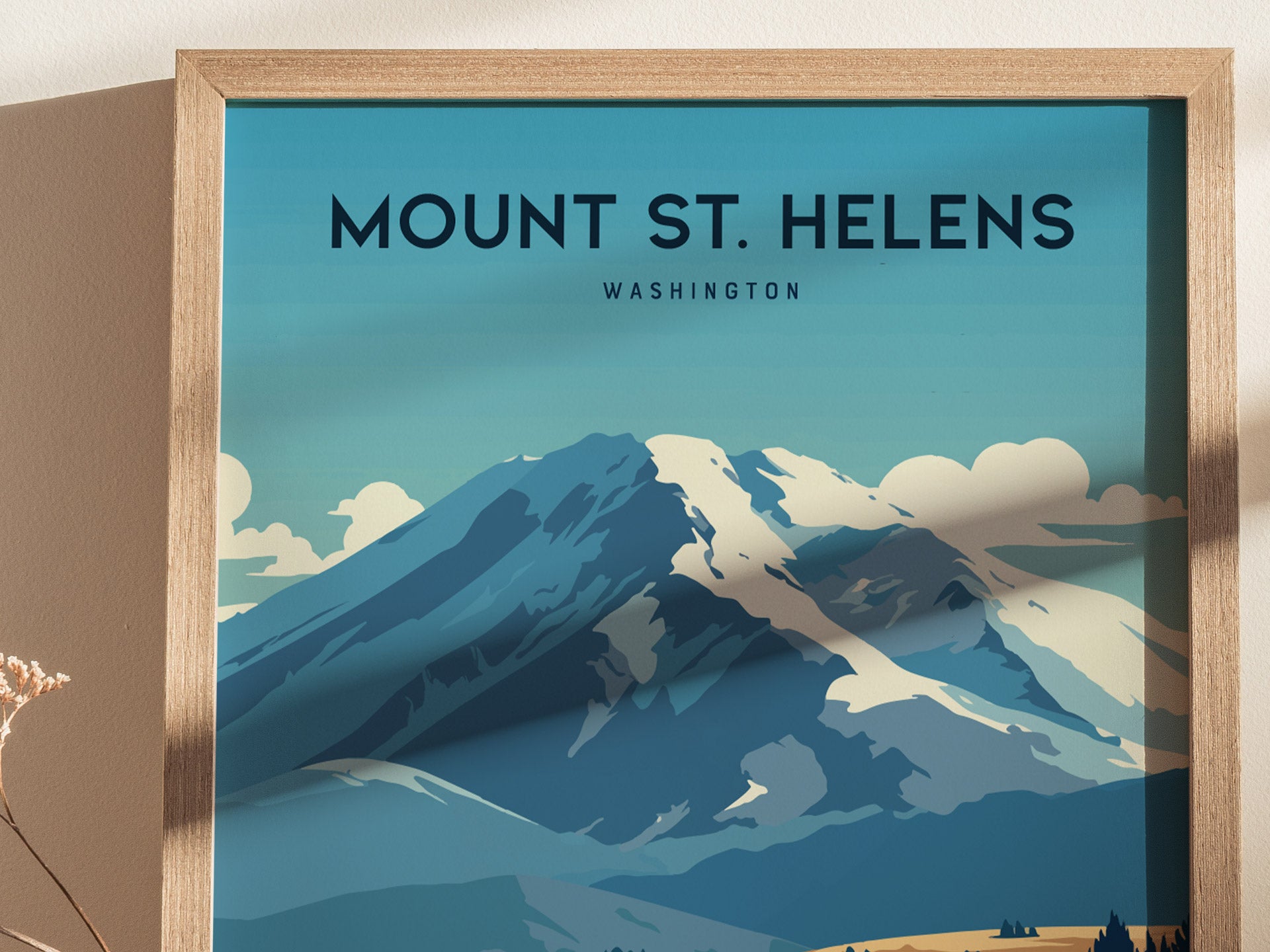 Illustrated poster of Mount St. Helens in Washington, featuring a stylized depiction of the snowy volcano under a blue sky, framed in light wood.