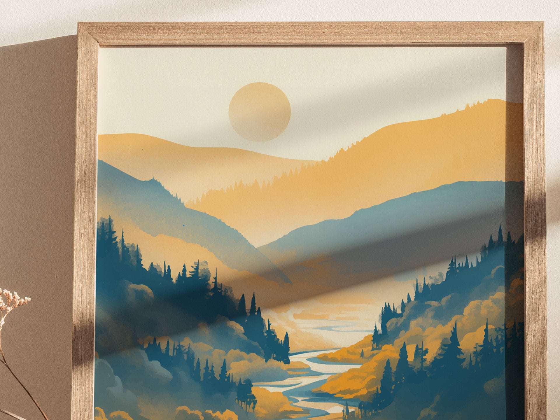 A framed poster depicts a stylized landscape of rolling hills and a river, with a warm sun setting over a serene valley. Shadows create depth and contrast.