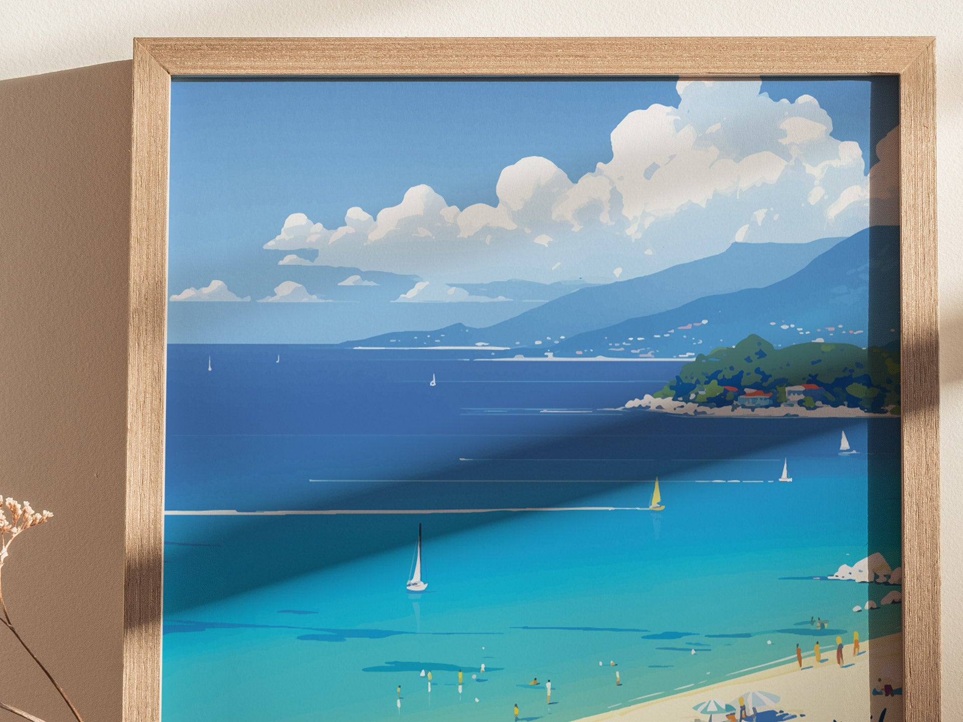 A framed poster depicts a serene coastal scene with turquoise waters, sailboats, and a mountainous horizon under a partly cloudy sky. The artwork includes a sandy beach with sunbathers.