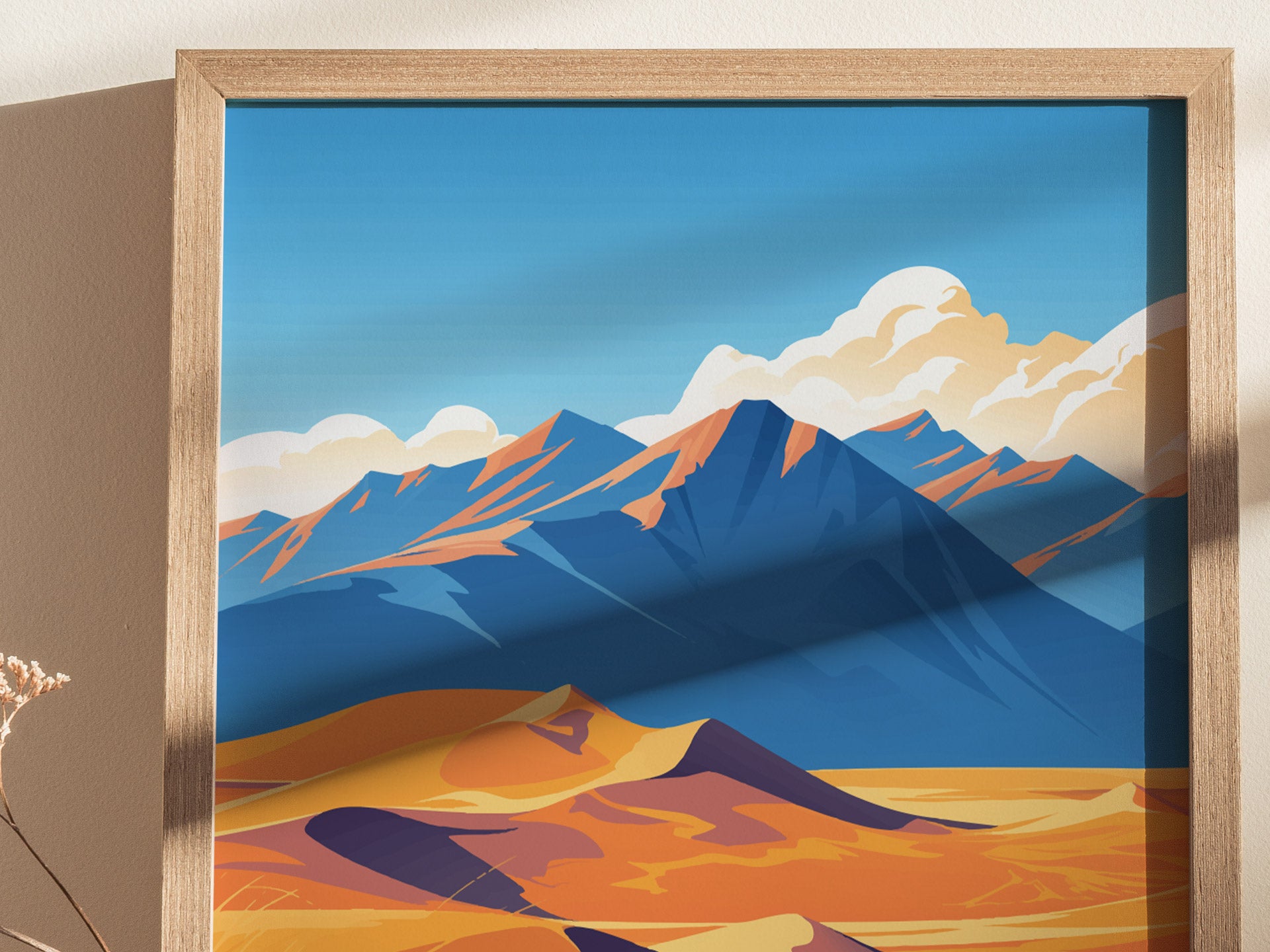 Framed poster depicting stylized artwork of Great Sand Dunes, Colorado, with vibrant orange dunes and blue mountains under a sky with fluffy clouds.