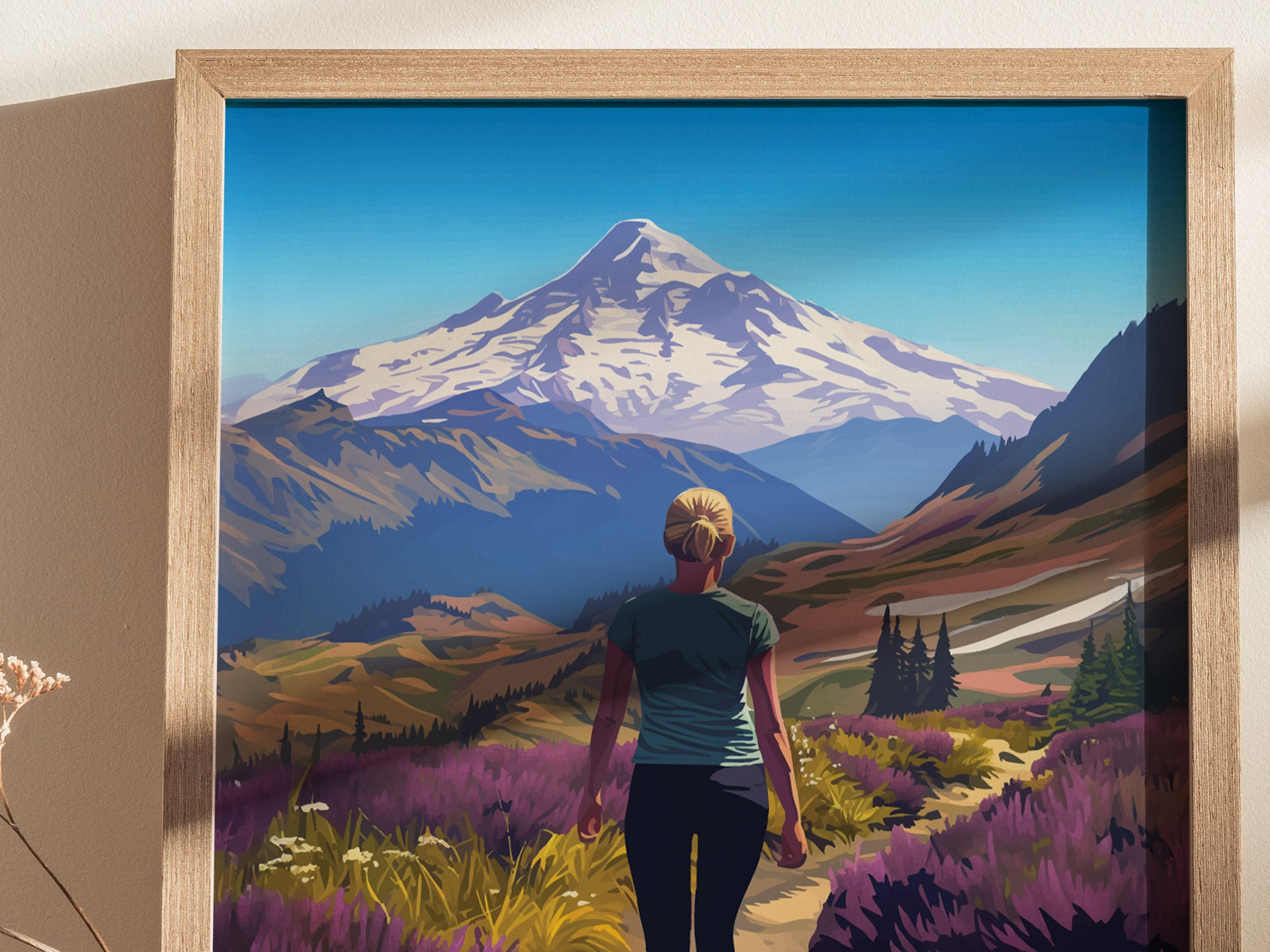 A framed illustration shows a person hiking through vibrant wildflower meadows with Mt. Baker in the background, under a clear blue sky.