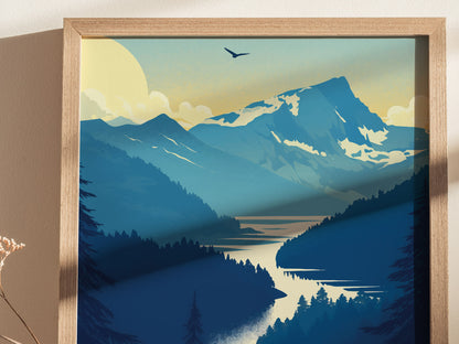 A framed poster depicting a stylized landscape of mountains and a winding river, with a bird flying above and a setting sun in the background.